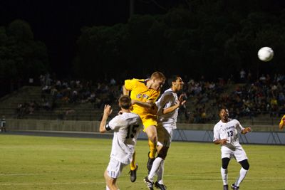 <strong>NICHOLAS VU |</strong><br>Staff Photographer Junior Corey Attaway heads the ball amidst a swarm of Aggie defenders. UCI ends up losing 2-1.