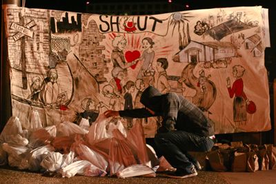 <strong>JOSE DANIEL RUIZ |</strong> Staff Photographer<br>A SHOUT volunteer picks up a plastic bag by the educational mural during the sleep-in on Thursday.