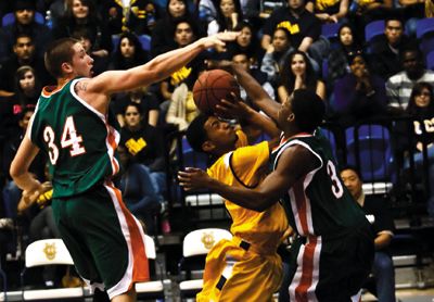 <strong>NICHOLAS VU |</strong> Staff Photographer<br>Senior Michael Hunter is smothered by the La Verne defense, but UCI would go on to win their home opener, destroying the Leopards 82-54.