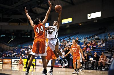 <strong>SCOTT ROEDER |</strong> Staff Photographer<br>Senior Keyonna Johnson drives to the basket against the much larger Princeton center, Devona Allgood. For UCI, this game was all bad.