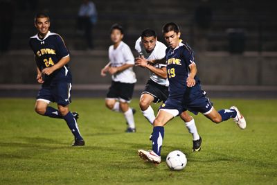 <strong>SCOTT ROEDER |</strong> Staff Photographer<br>Freshman midfielder Jonathan Prieto takes a shot upfield while junior defender Jorge Reyes lends support.