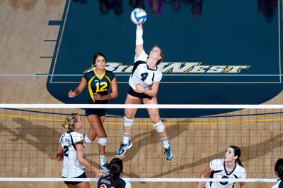<strong>SCOTT ROEDER |</strong> Staff Photographer<br>Kari Pestolesi (4) spikes the ball against Cal State Fullerton as Kristin Winkler (12) looks on. UCI wins 3-0.