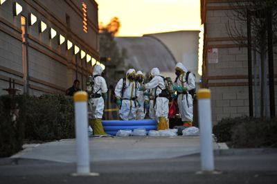 <STRONG>SCOTT ROEDER</STRONG> | Staff Photographer <BR>The Hazardous Materials team gathers to remove one of the “Black Death” letters from the Claire Trevor School of the Arts and test it to determine whether it is a biological hazard.  