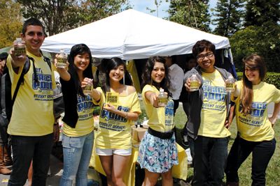 Claudia cheffs | Staff Photographer Grace Poon, a third-year economics major who was running against Jun Wang for the role of Vice President of Student Services, campaigns with the help of some friends on Ring Road, passing out personalized water bottles to encourage people to vote.