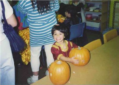 Four-year-old Rashmi proudly holds her carved Halloween pumpkin, not knowing that her name would be the cause of confusion and laughs.