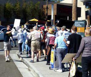Senior citizen activists march outside Walters's office.