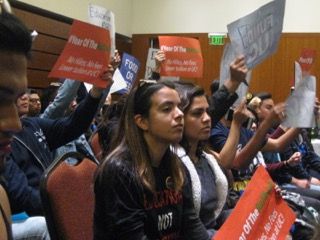 Students at UC Regents meeting inside.