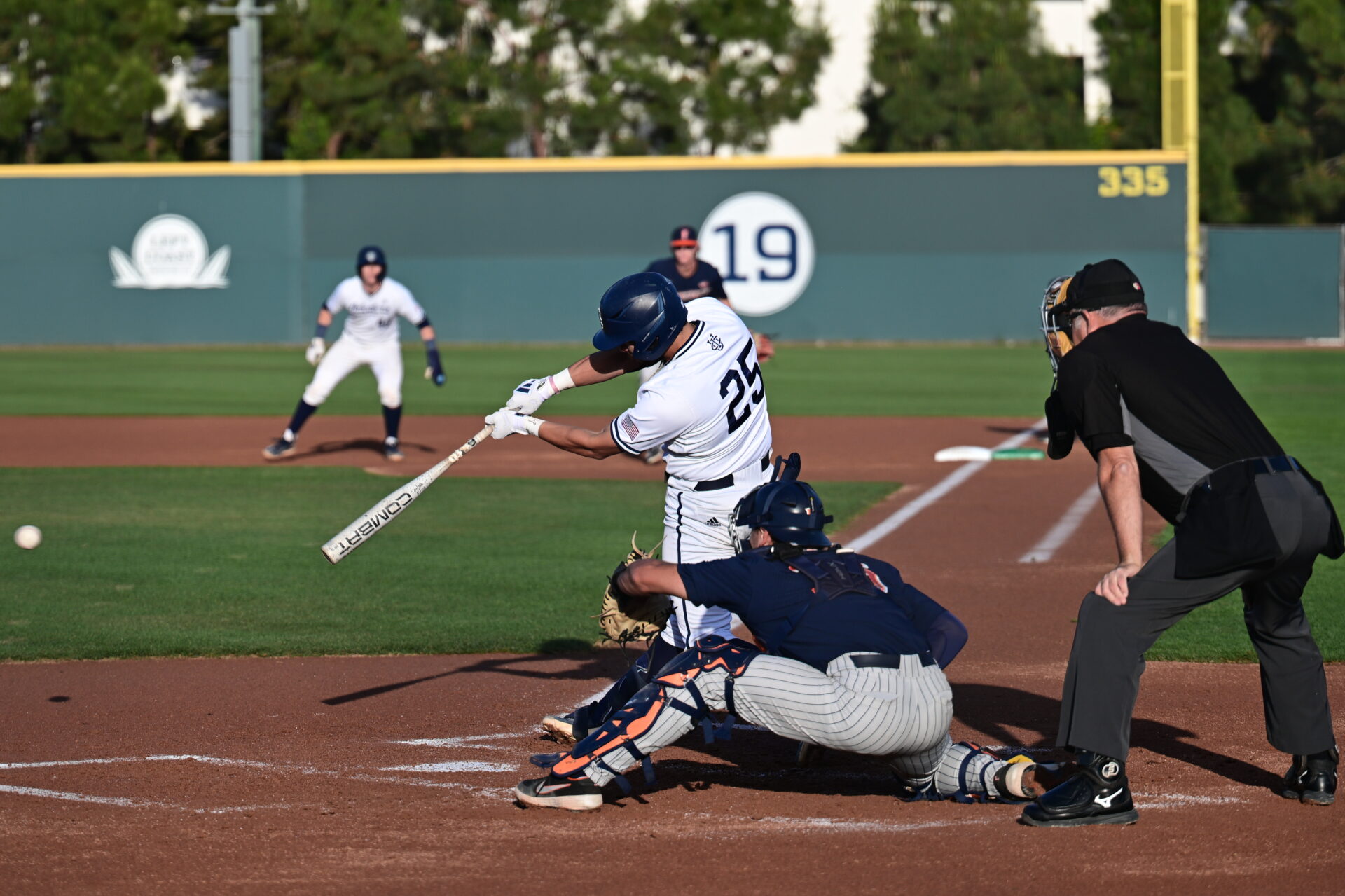 A UC Irvine batter swings at a ball with a runner on first base