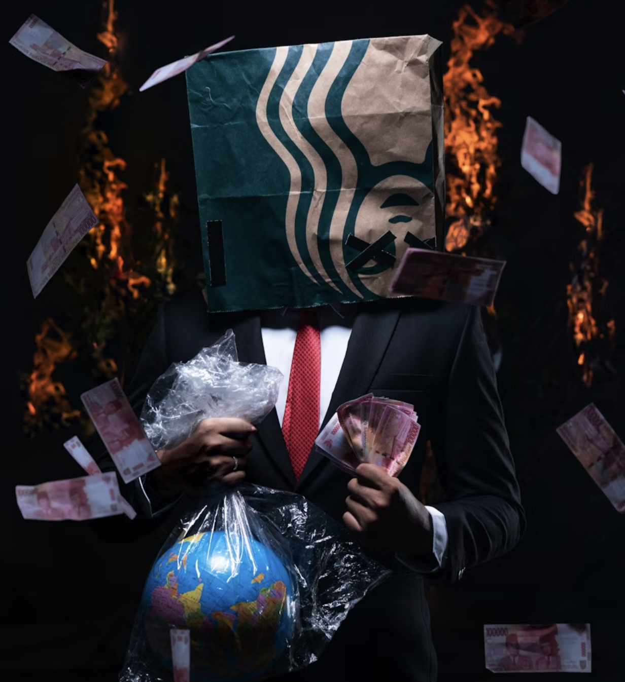 A man in a suit holds cash in one hand and a globe wrapped in plastic in the other. A Starbucks bag covers his head entirely as cash and flames fill the dark background.
