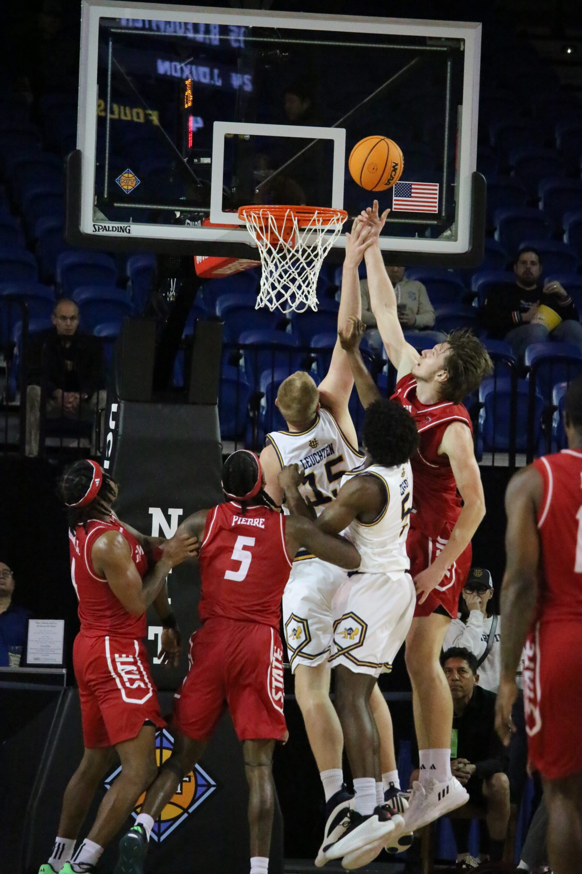 Two UC Irvine and four Jacksonville State players contest a basketball