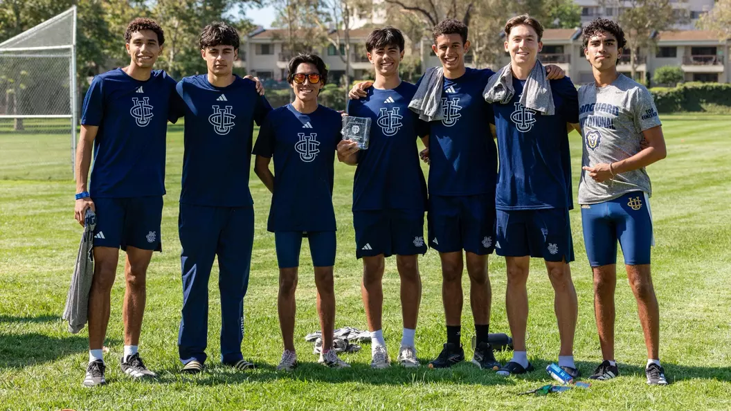 Men's cross country runners pose for a photo at Mason Regional Park in Vanguard Invitational gear
