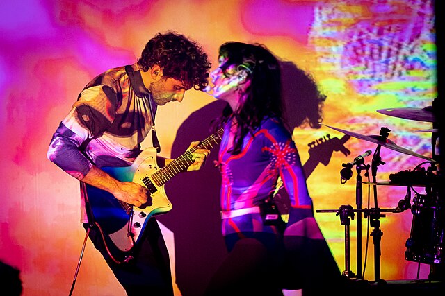 Matthew Lewin of Magdalena Bay plays electric guitar as Mica Tenenbaum sings at a Magdalena Bay performance.