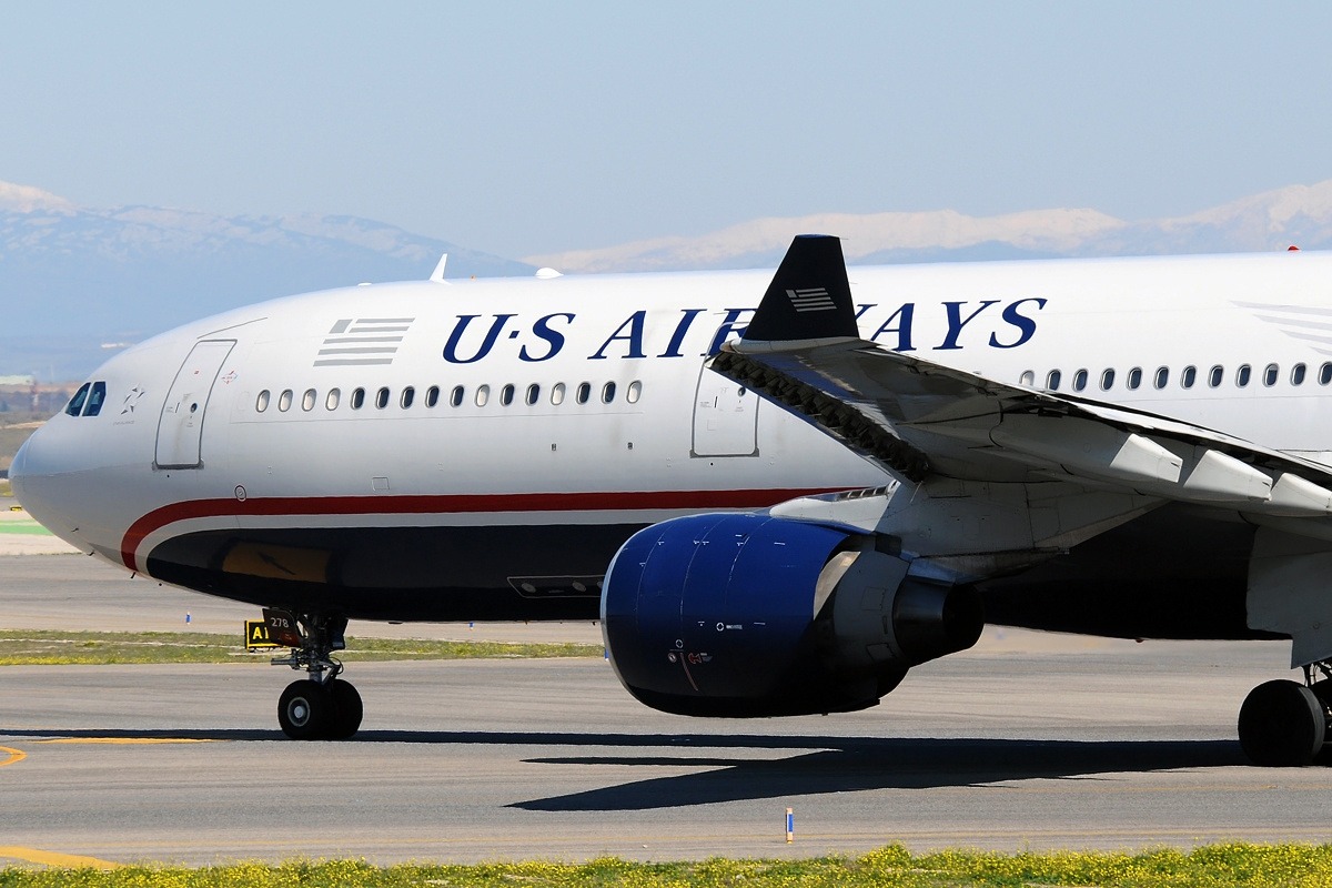 The front side part of a U.S. Airways airplane is shown on a runway.