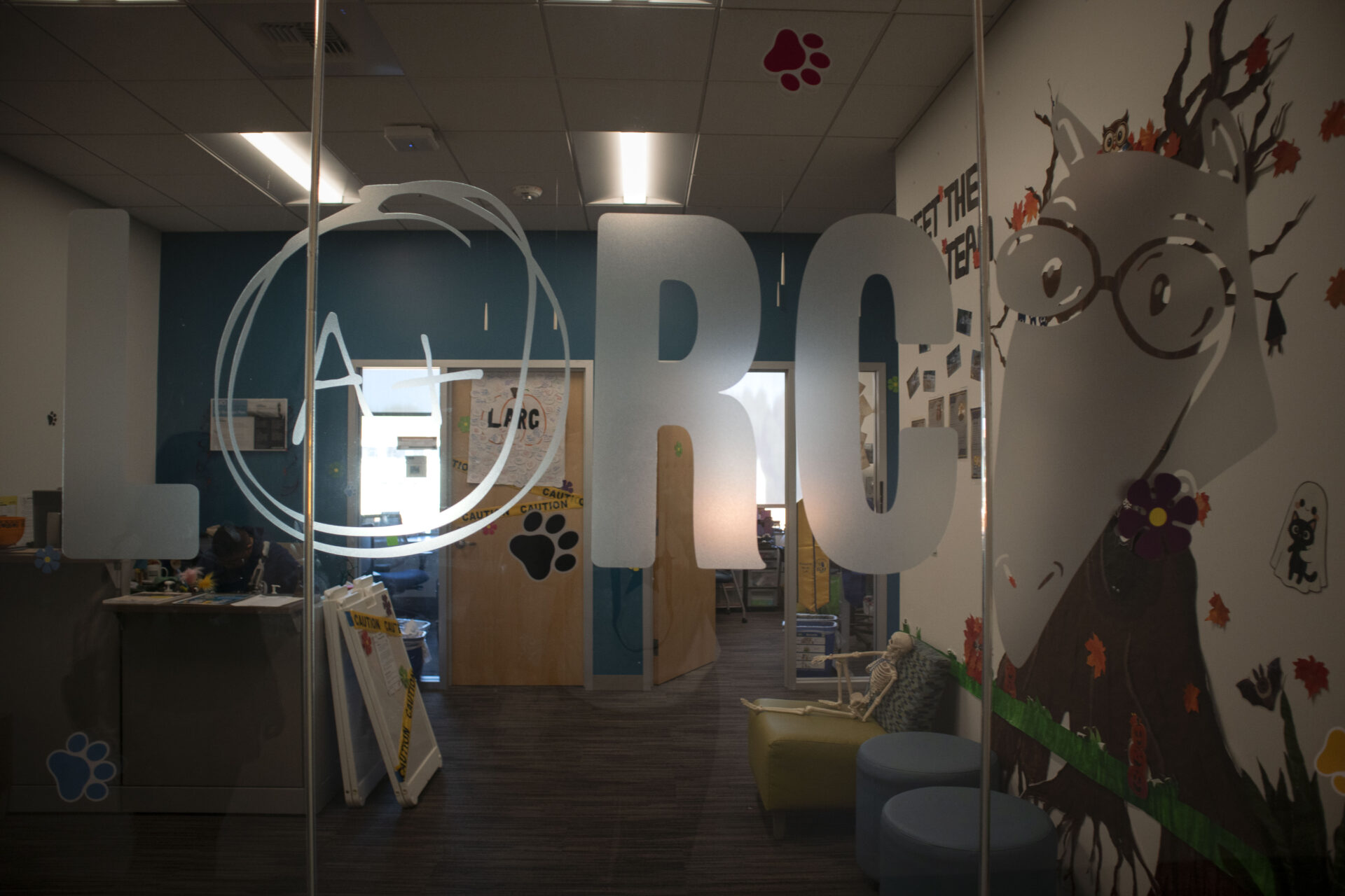 The LARC lobby is visible through the class. Part of the frosted glass is a Petr the Anteater graphic.