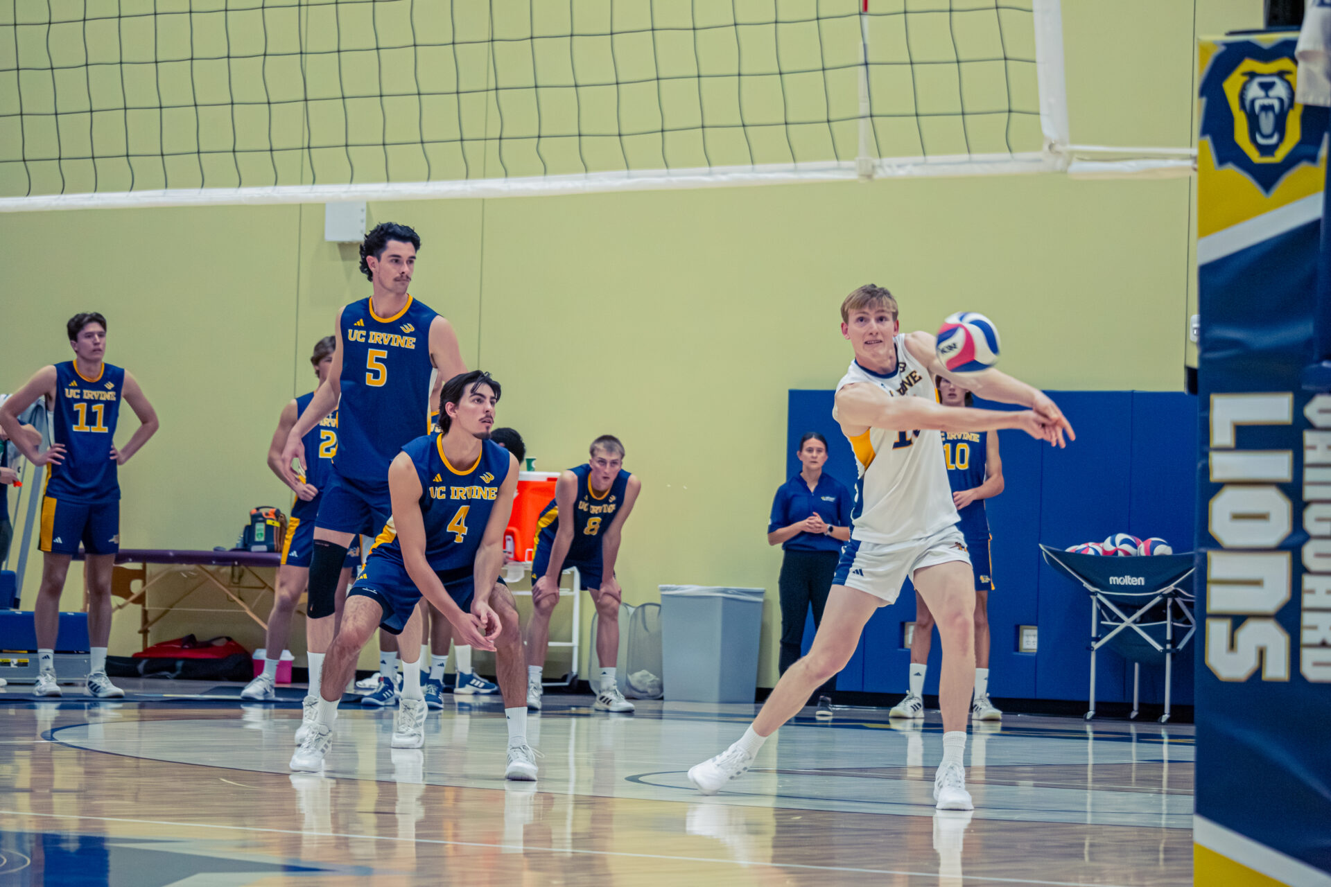Players watching teammate pass the ball