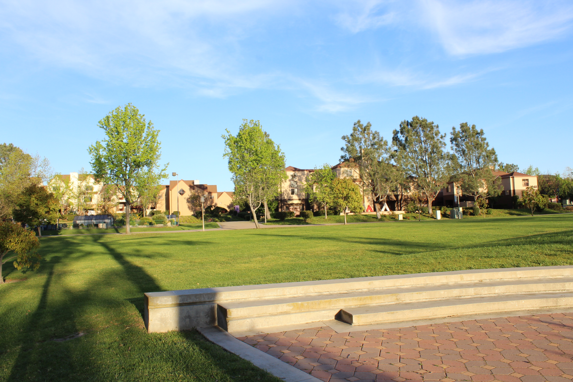 A shot of the edge of Arroyo Vista Student Housing on a sunny day. Trees cover the the dorms in the background.