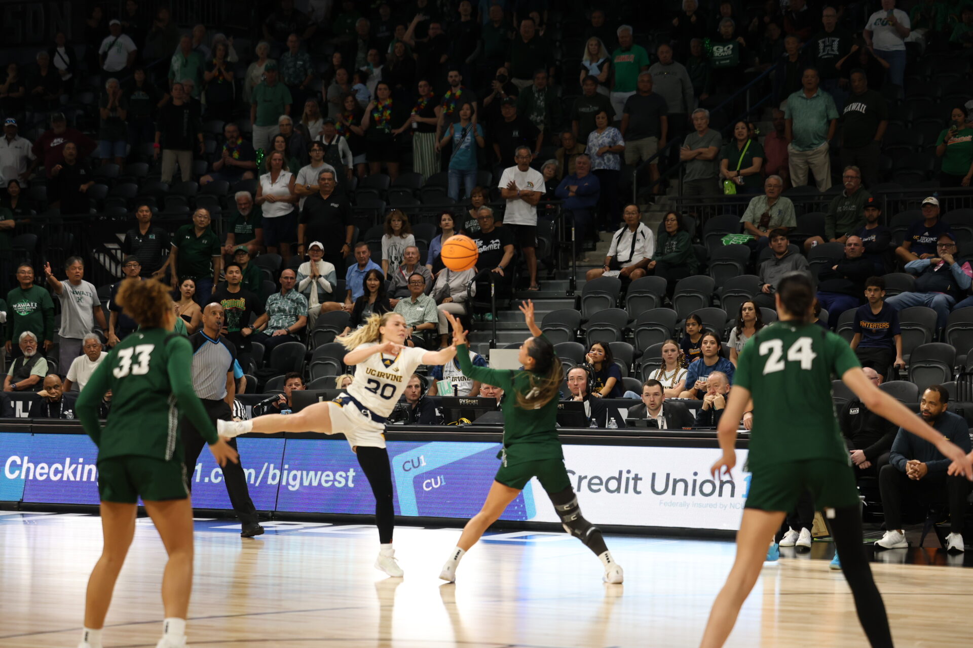 Three Hawai'i players look to steal the ball from Hunter Hernandez