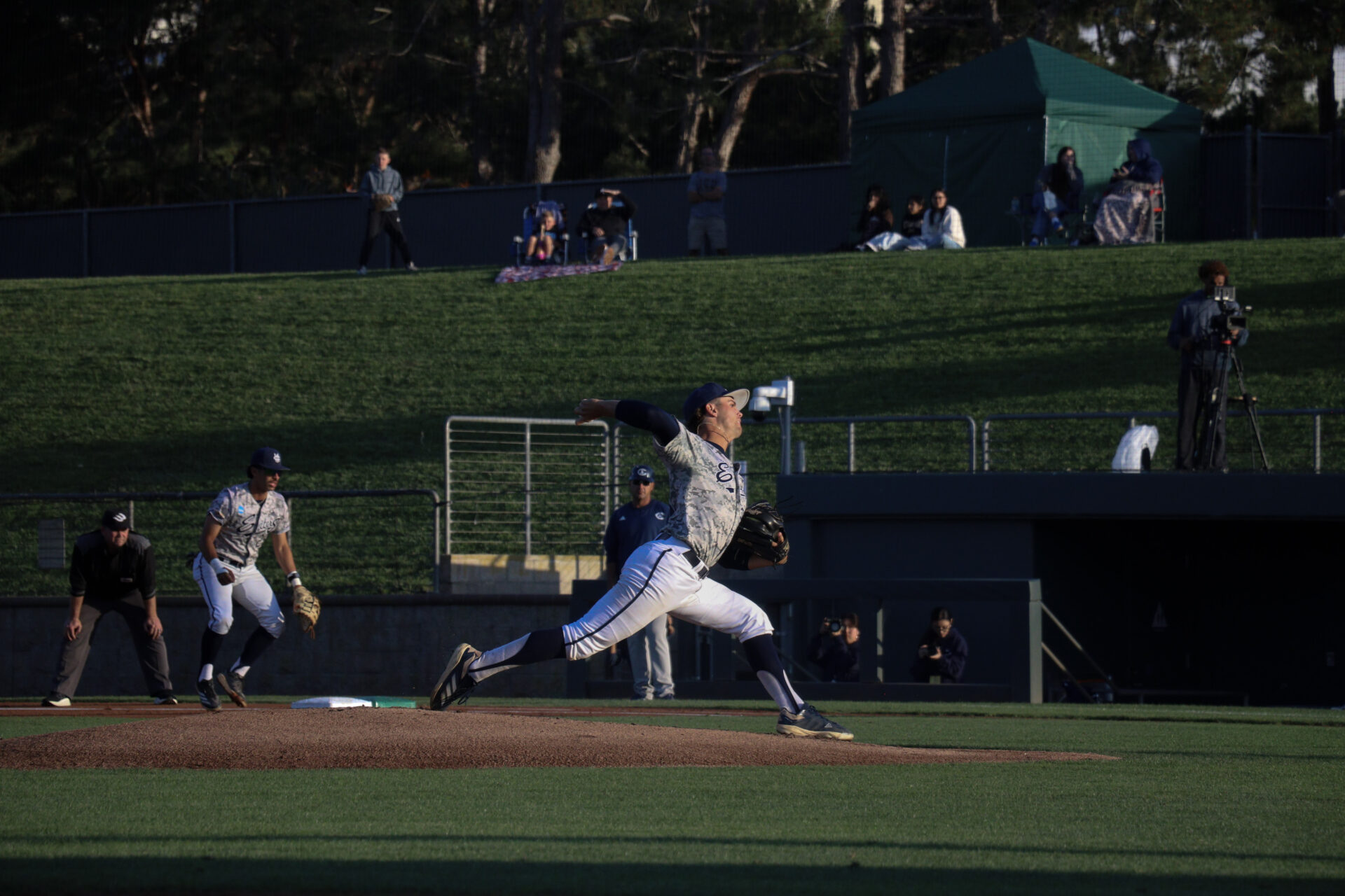 UC Irvine player number twenty eight, Trevor Hansen, pitches a ball that strikes out UC Davis batter.