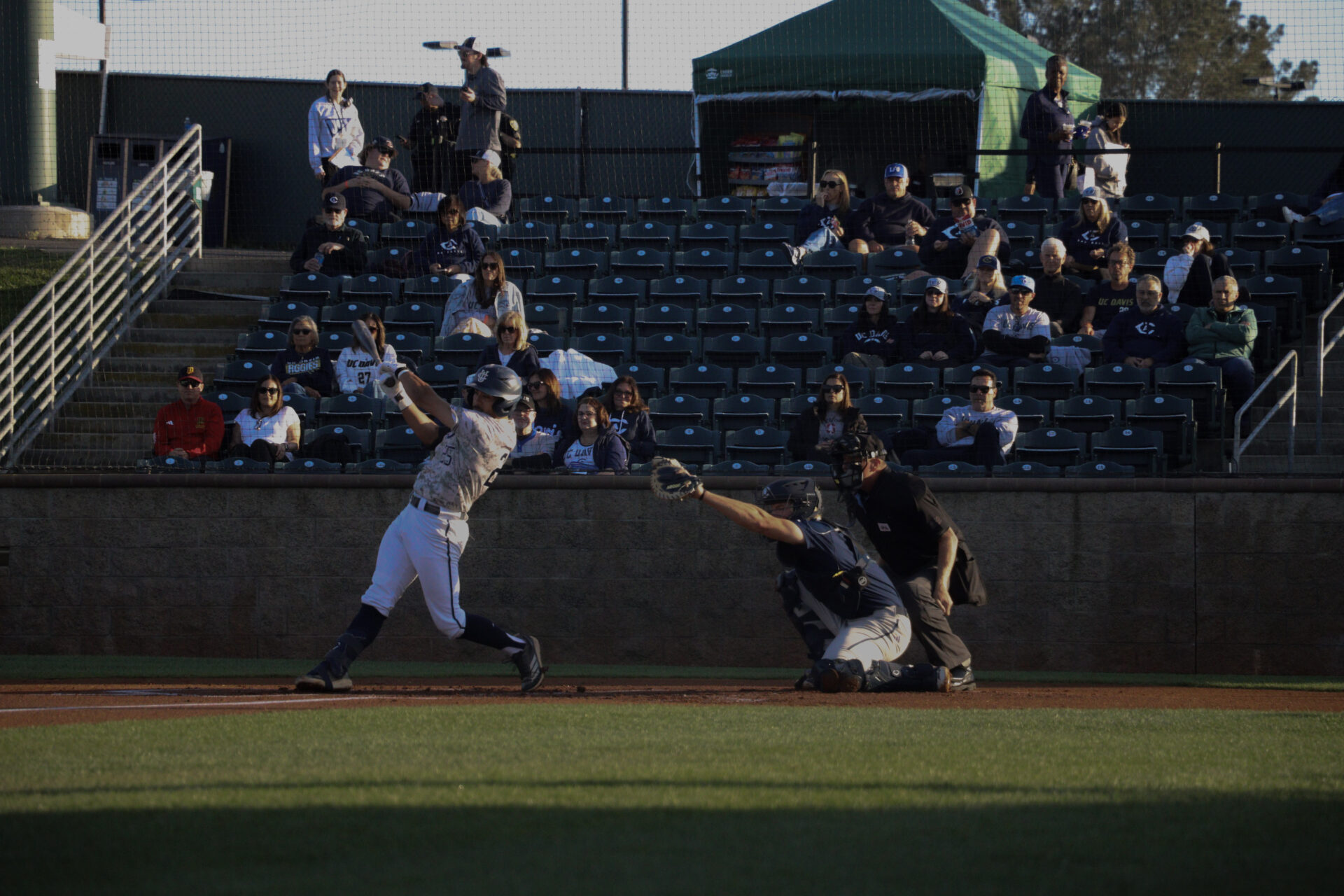UC Irvine player number twenty five Alonso Reyes, swings at ball, but UC Davis catcher catches it. Reyes strikes out.