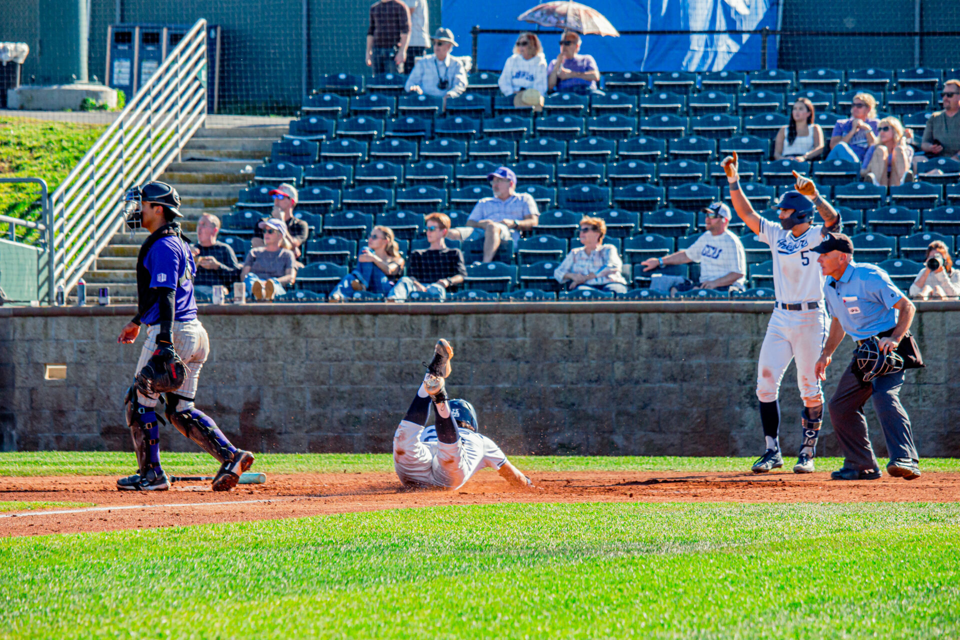 Player throwing themselves onto home base