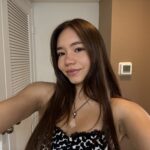 A selfie oof Michaela Okuyama in a polka dot tank top.