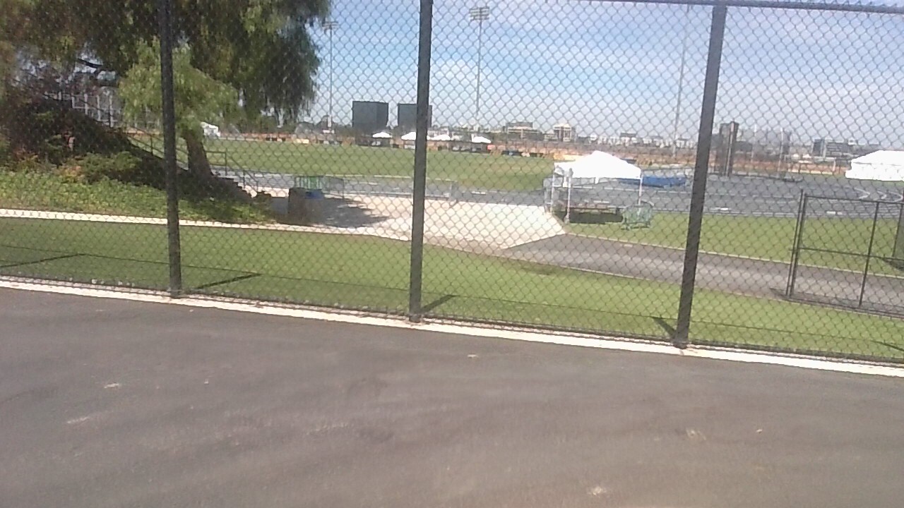 Outside a stadium with a field, high jump area and track