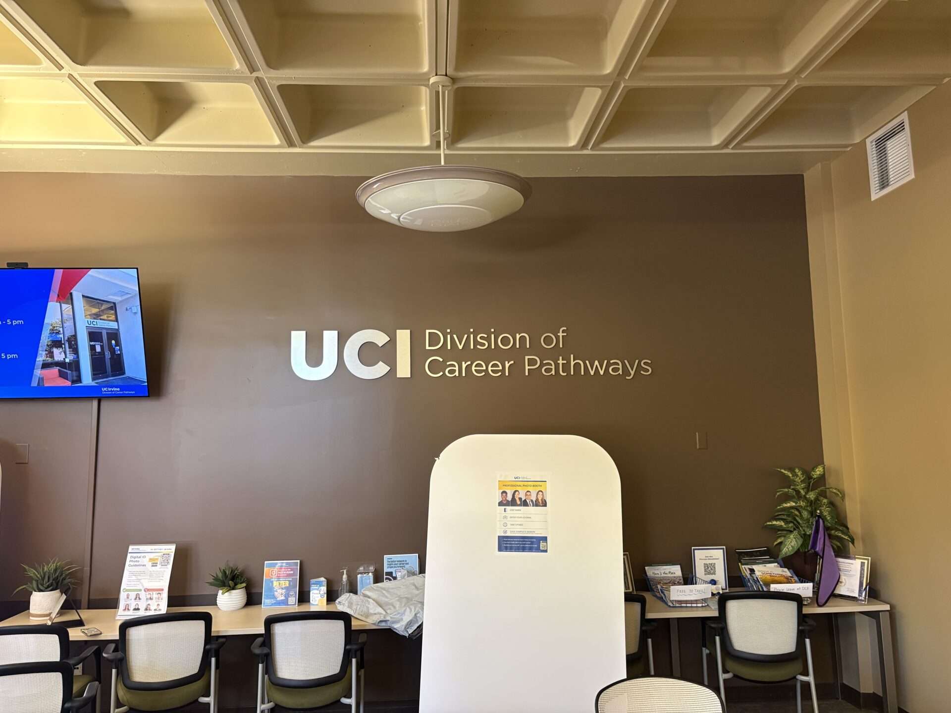 The lobby of UCI's Division of Career Pathways, with gold and silver lettering reading 