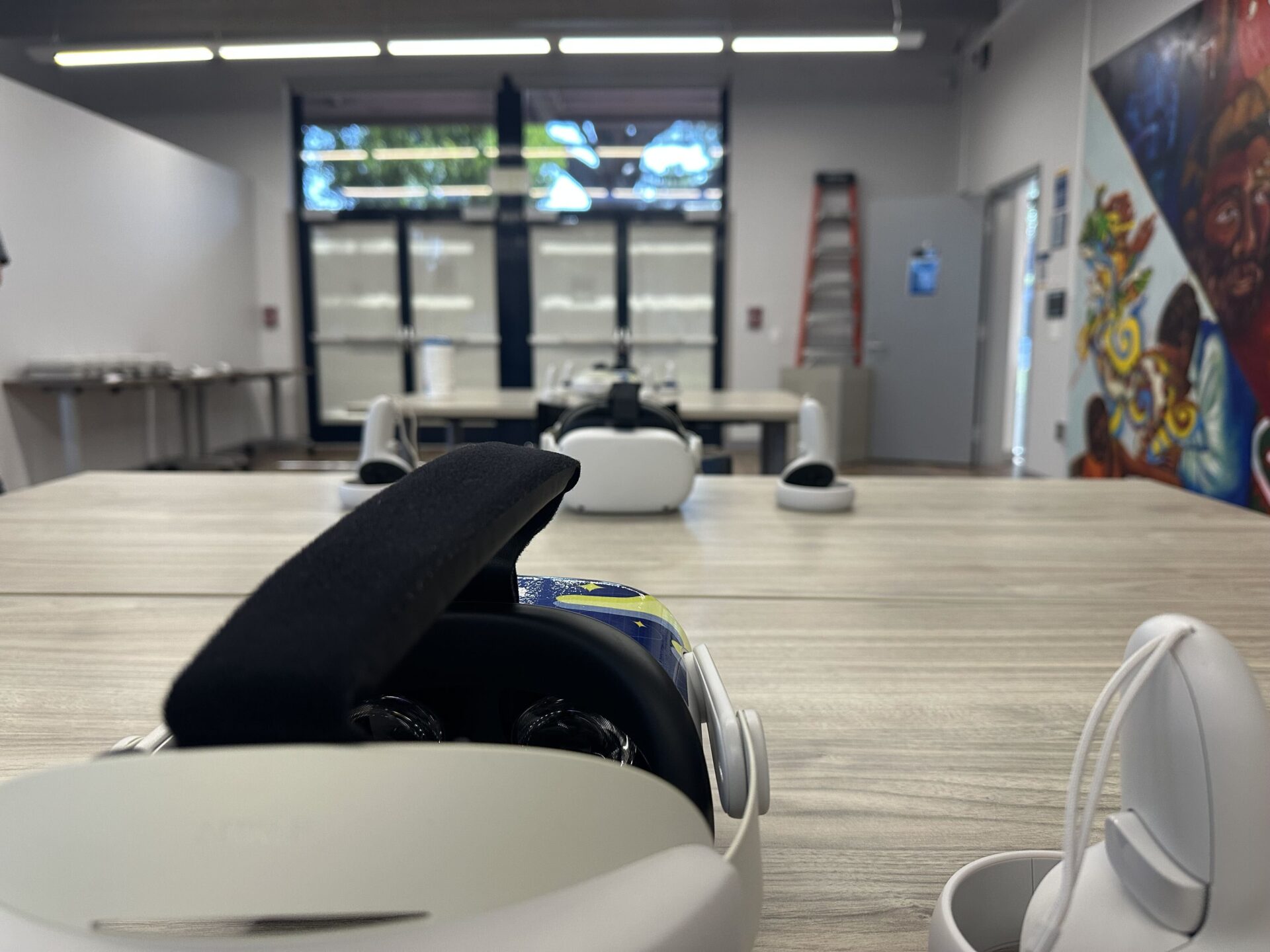 Two VR headsets sit on a wooden table