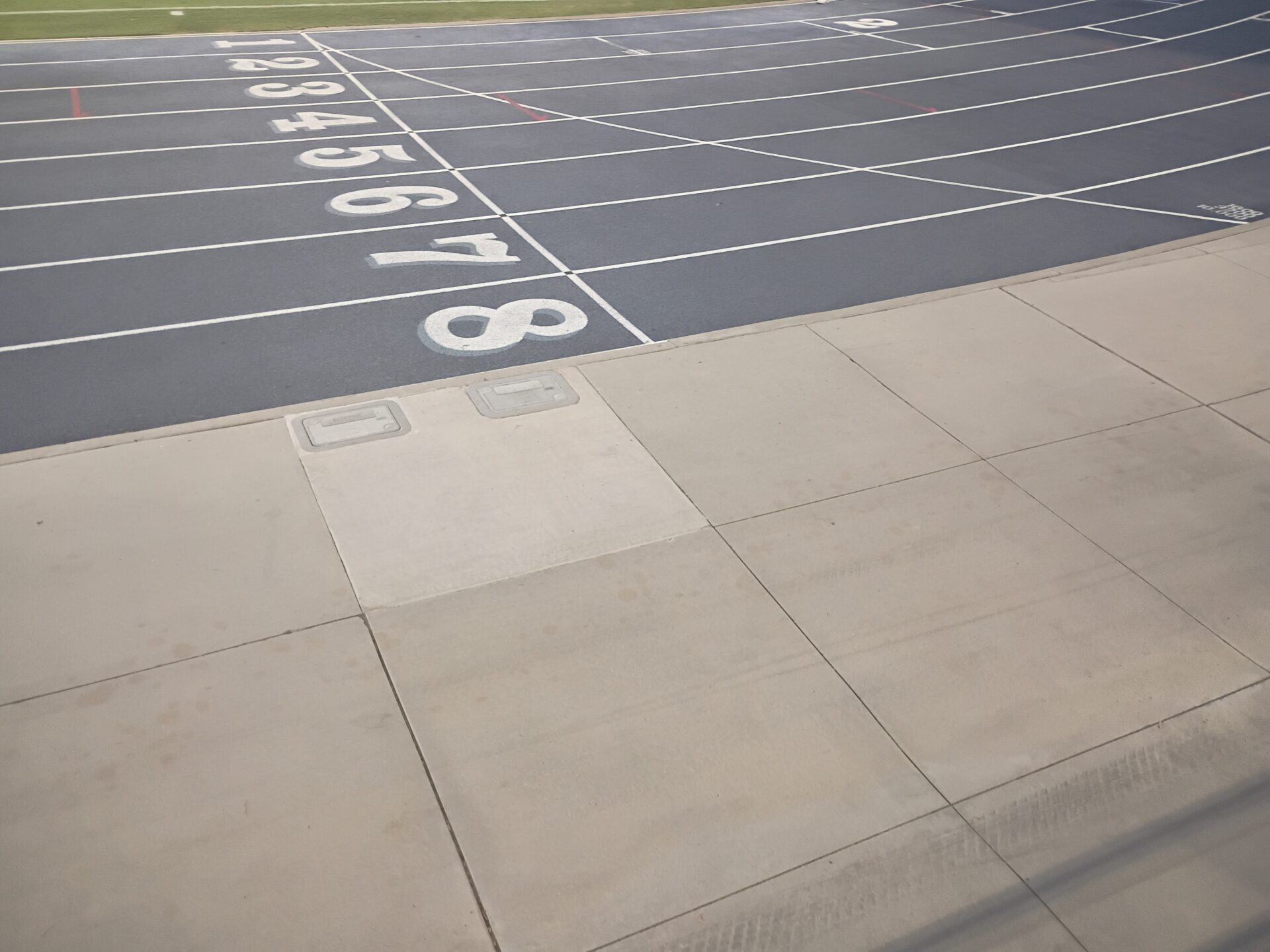 The finish line at Anteater Stadium with numbers 1-8 in numeral form